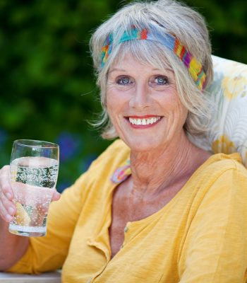 retired lady drinking water cropped